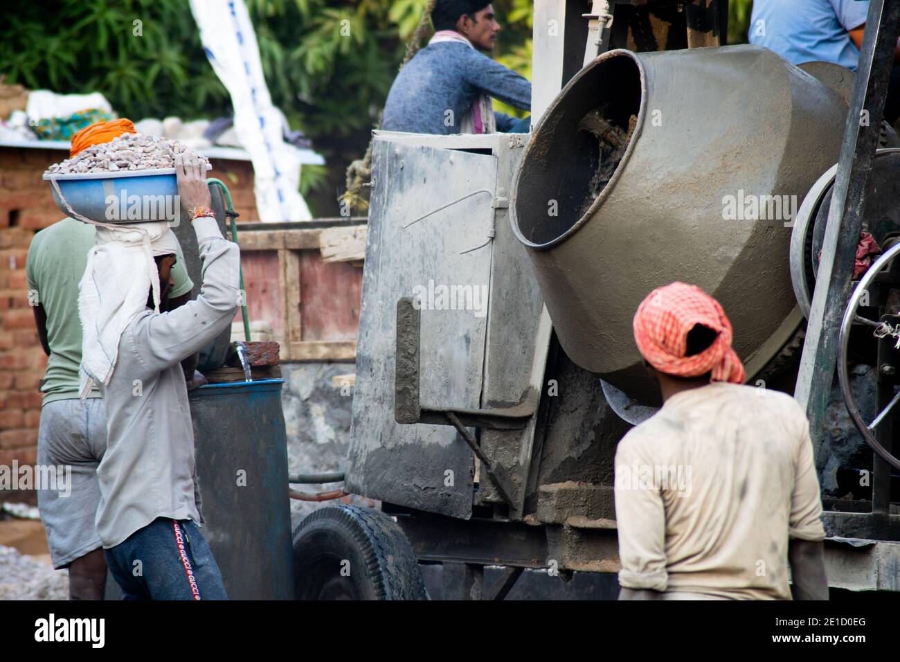zoomed in shot of indian underprivleged construction workers carrying