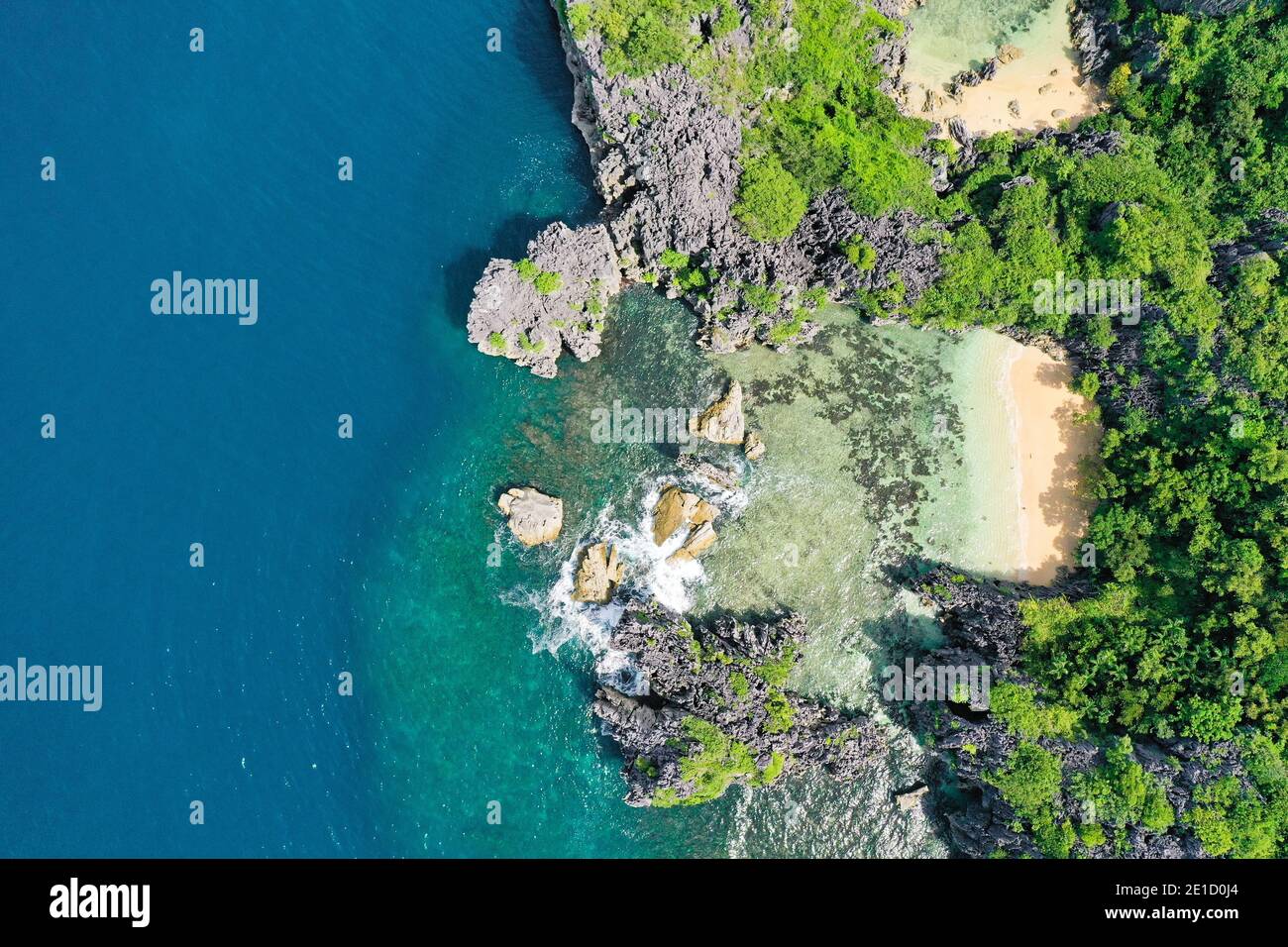White sand beach on a tropical island, top view. Aerial top view of ...