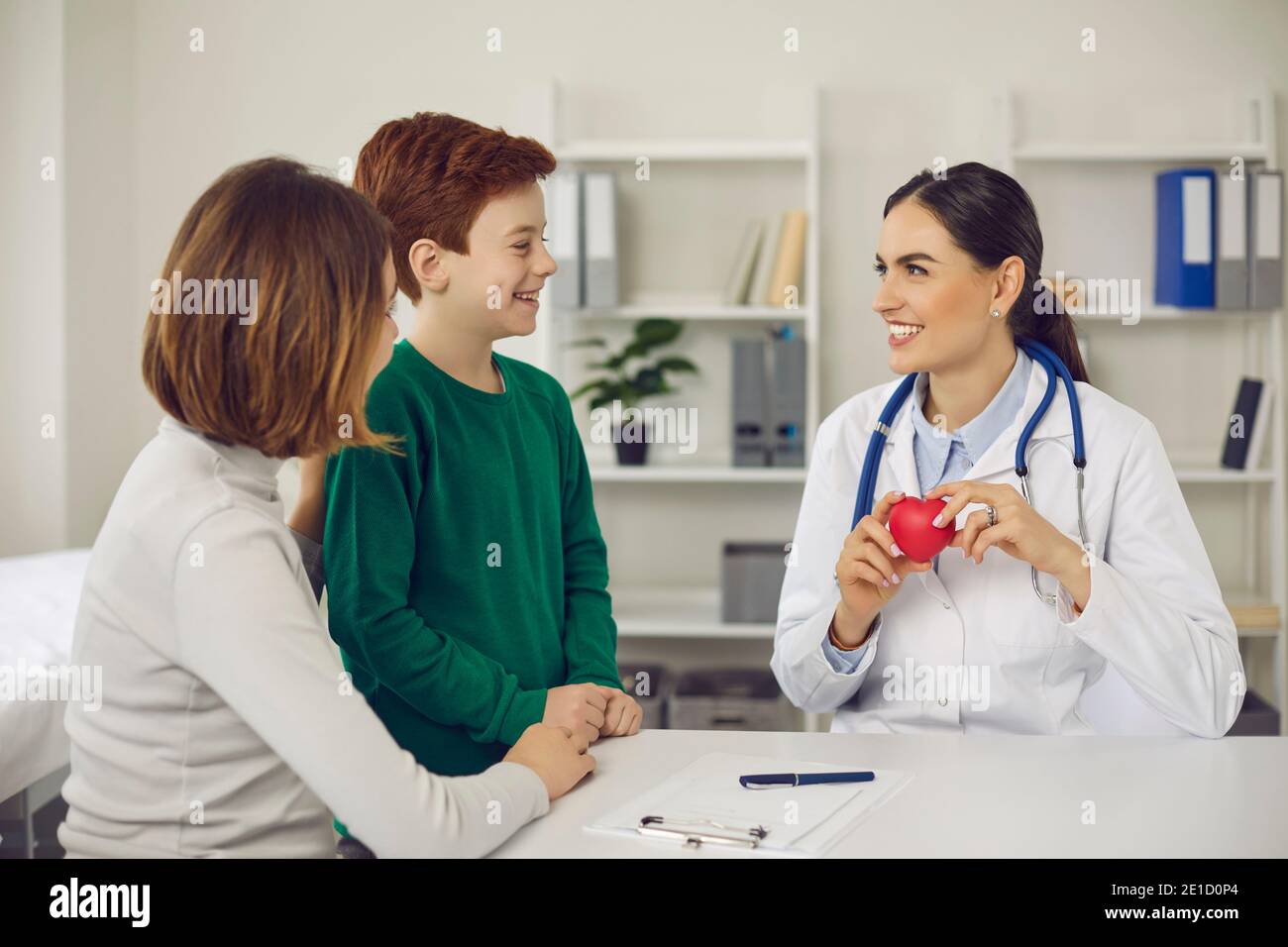 Doctor telling woman and her son about importance of healthy lifestyle for heart health Stock Photo