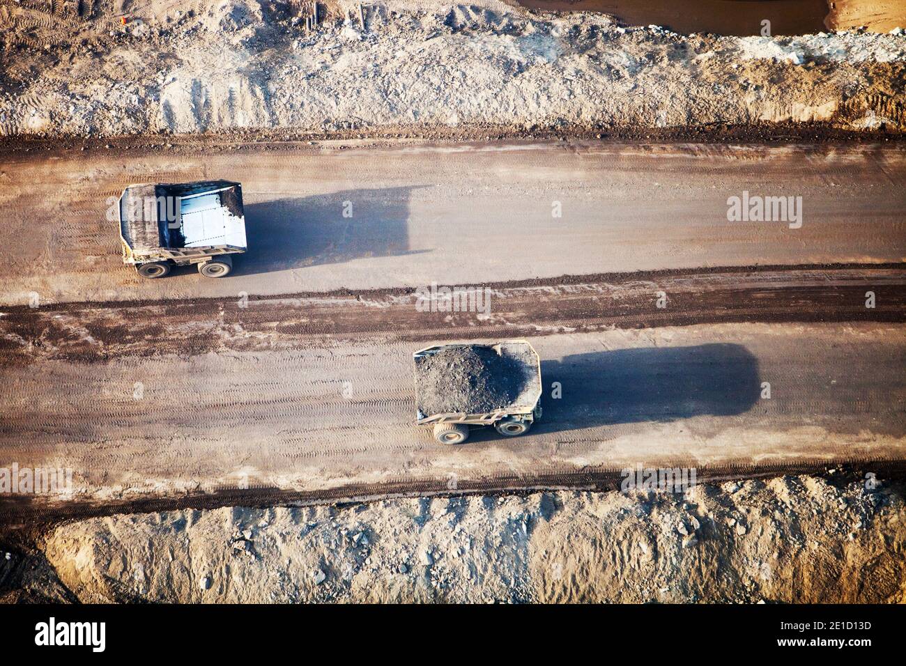 Massive dump trucks loaded with tar sand in a mine north of Fort McMurray, Alberta, Canada. The