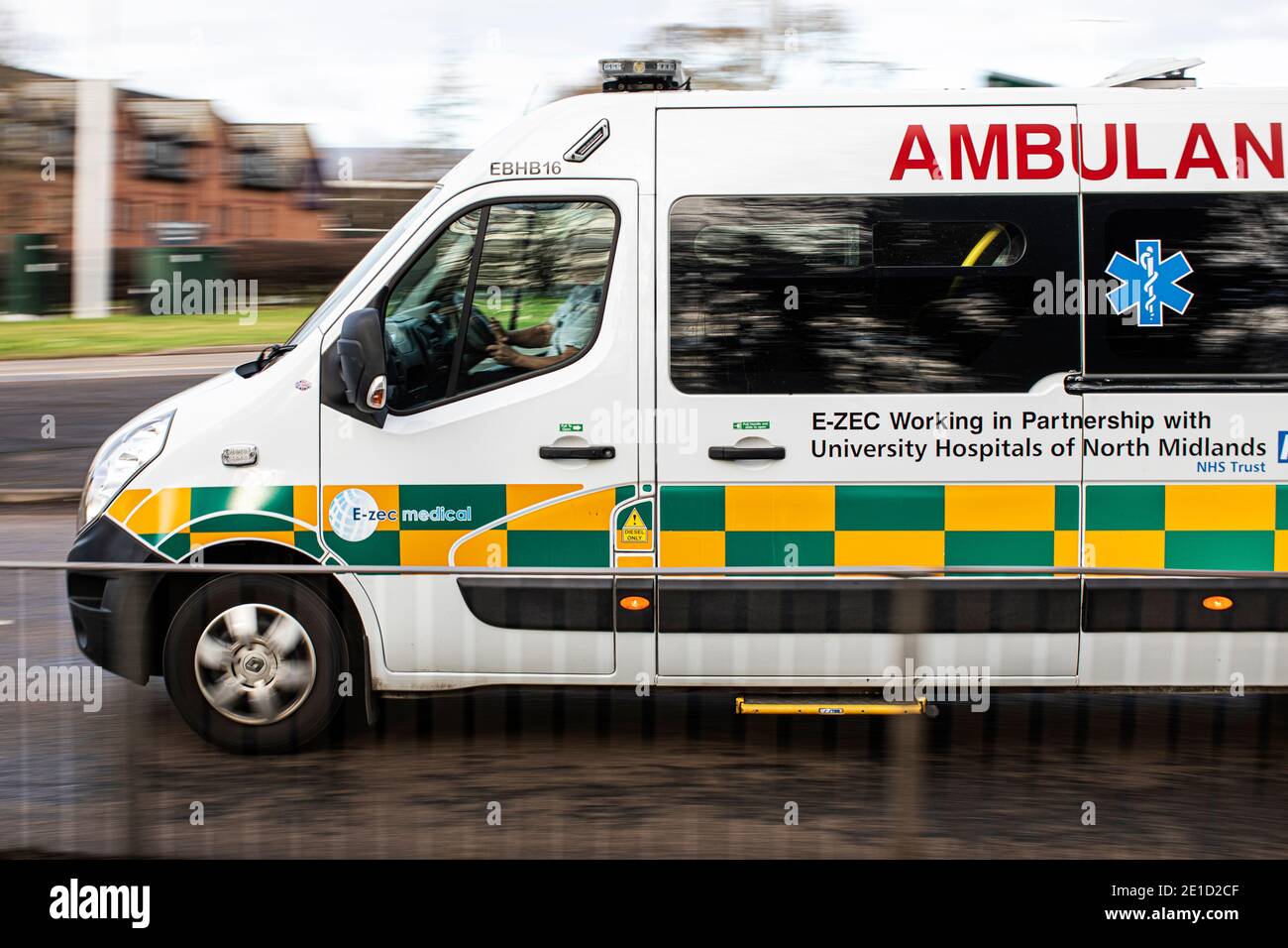 E-ZEC ambulance on blues and twos in the UK on emergency call out during pandemic Stock Photo