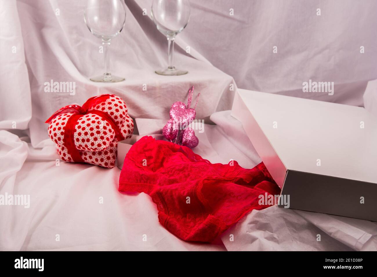 Lacey lingerie, ornamental hearts, and wine are all symbolic of the Valentine Holiday. Stock Photo