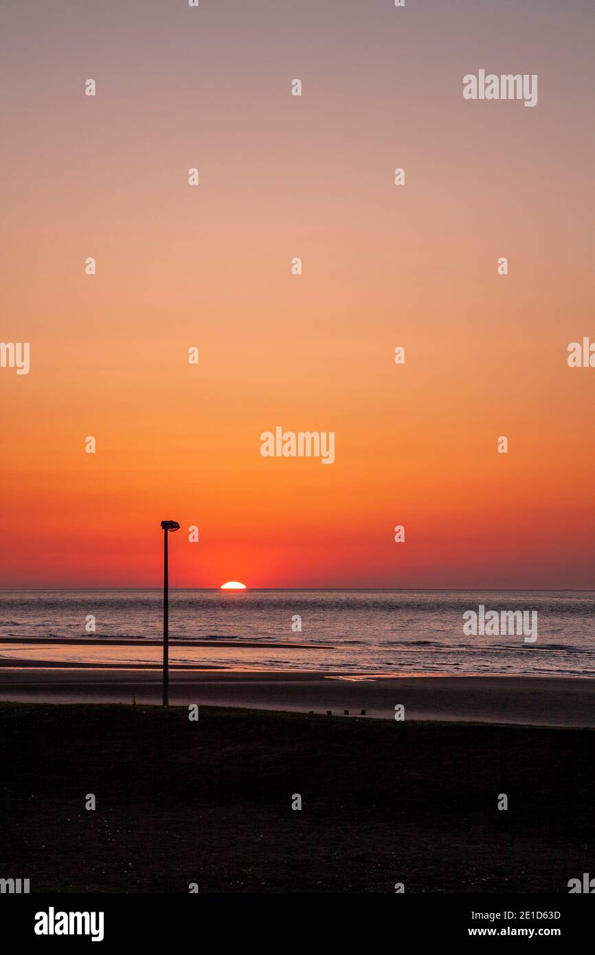 Rhyl beach at sunset on the North Wales coast Stock Photo