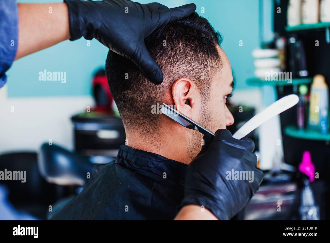 latin Barber Shop, Mexican barber cutting hair with a clipper machine