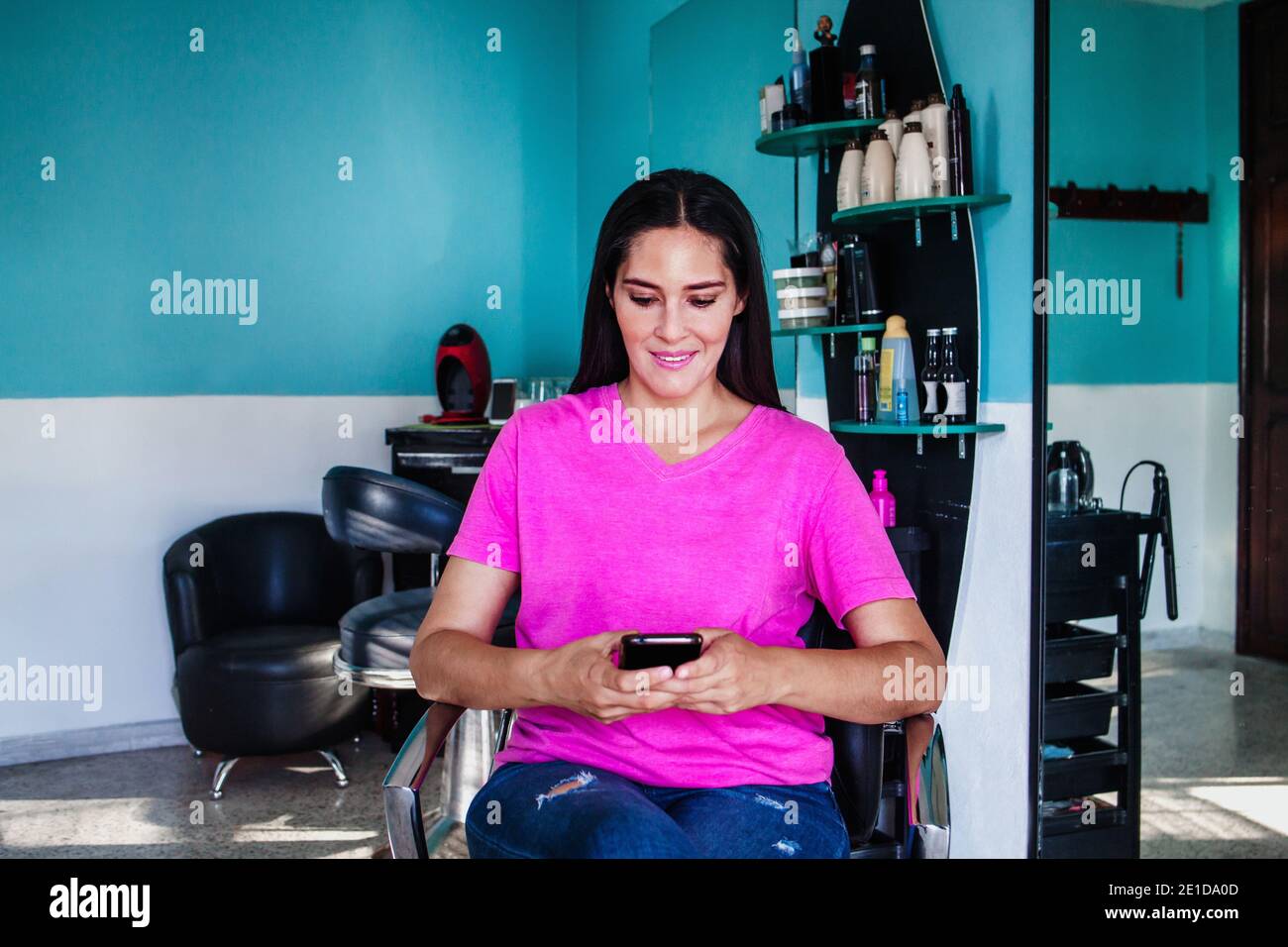 Latin woman who owns her haircut business in Mexico city Stock Photo