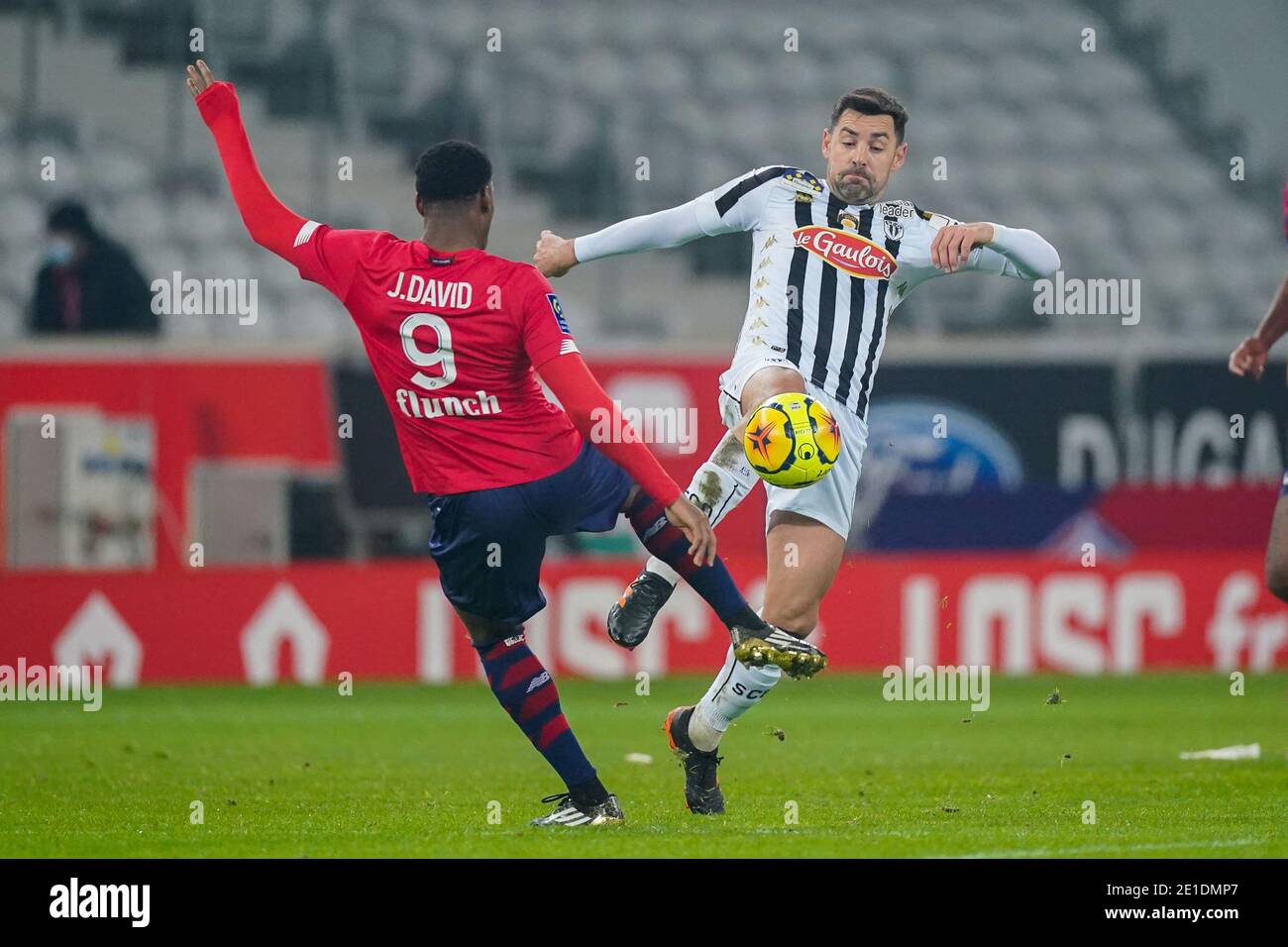 LILLE, FRANCE - JANUARY 6: Jonathan David of Lille OSC, Thomas Mangani of  Angers SCO during the Ligue 1 match between Lille OSC and Angers SCO at  Stade Pierre Mauroy on January