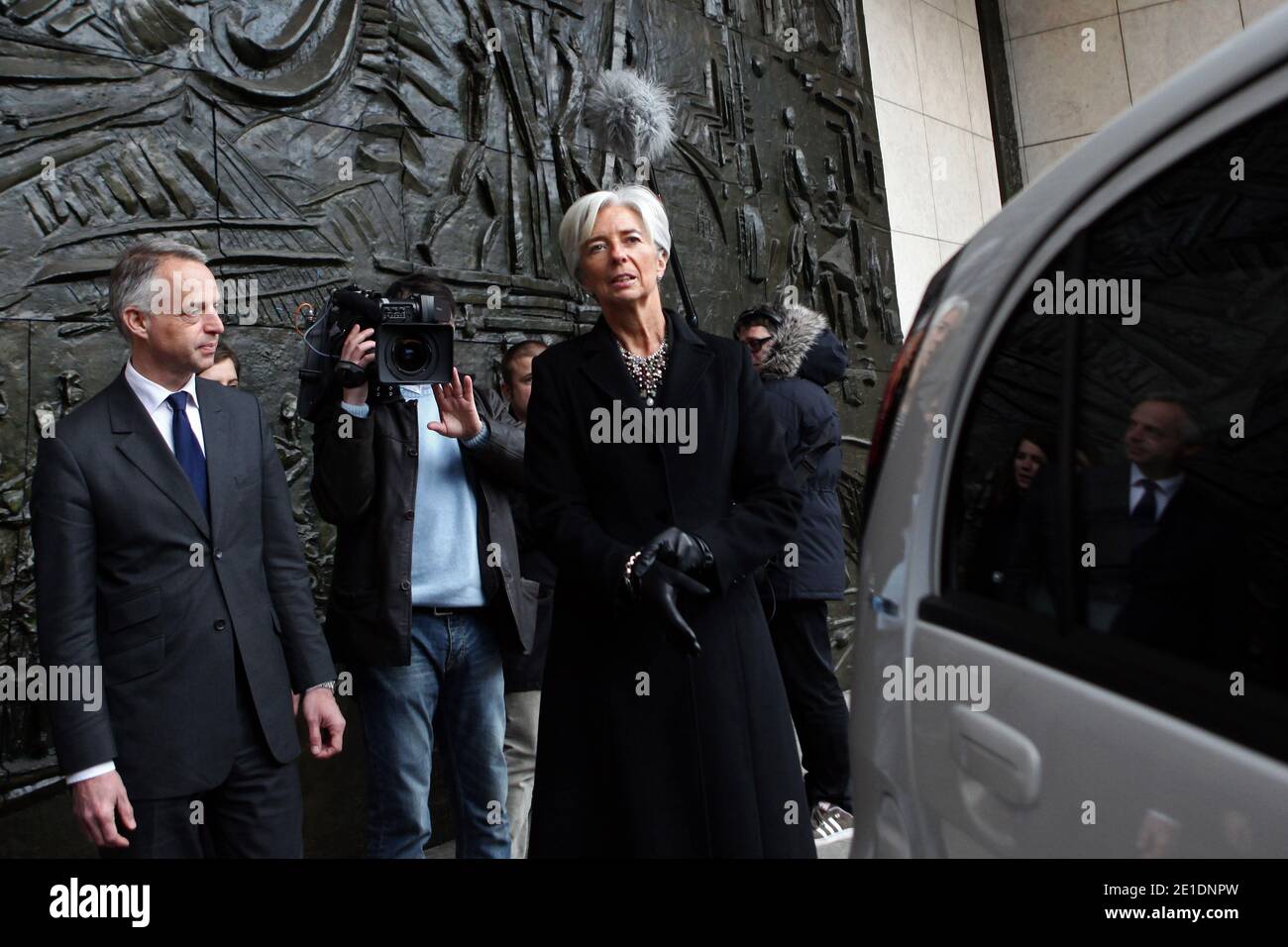 French Minister for the Economy, Finance and Industry Christine Lagarde shows how to charge the batteries of an Ion Peugeot full electric car near Peugeot Managing Director Vincent Rambaud, in Paris, France, on January 20, 2011. The Economy ministry will use the four seat four-door city ion car, launched at the end of 2010. Photo by Stephane Lemouton/ABACAPRESS.COM Stock Photo