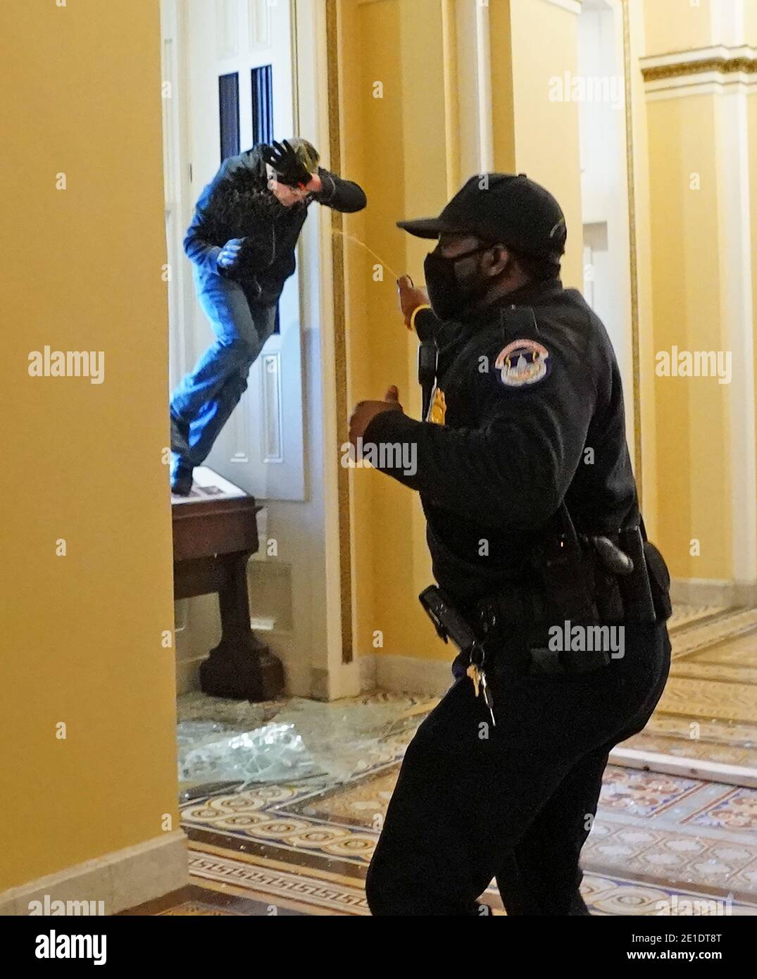 Washington, United States. 06th Jan, 2021. A U.S. Capitol police officer shoots pepper spray at a protestor attempting to enter the Capitol building during a joint session of Congress in Washington, DC on Wednesday, January 6, 2021. Photo by Kevin Dietsch/UPI Credit: UPI/Alamy Live News Stock Photo