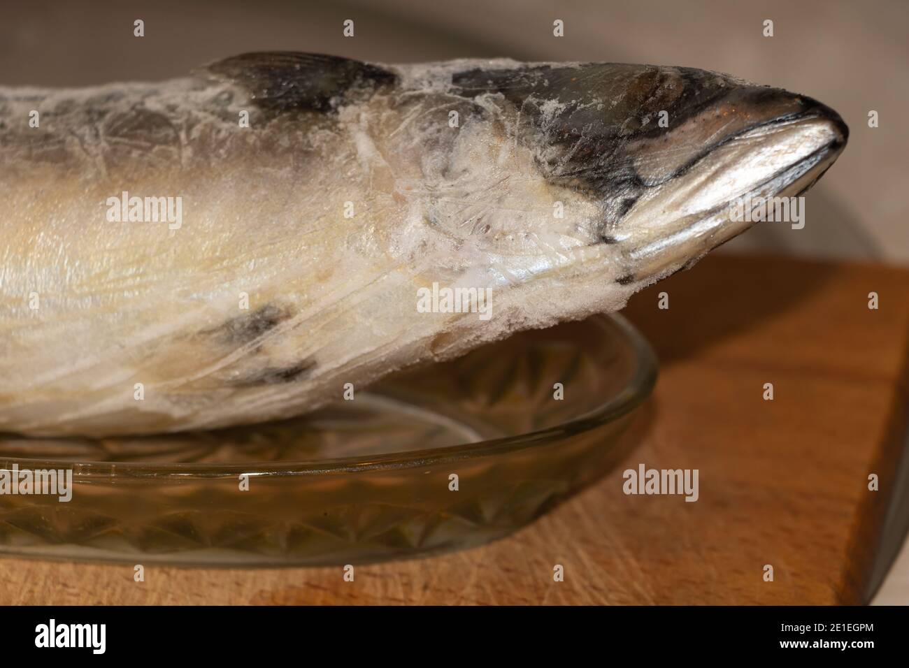 A frozen fish in the kitchen ready to cook. Benefits of fish dishes