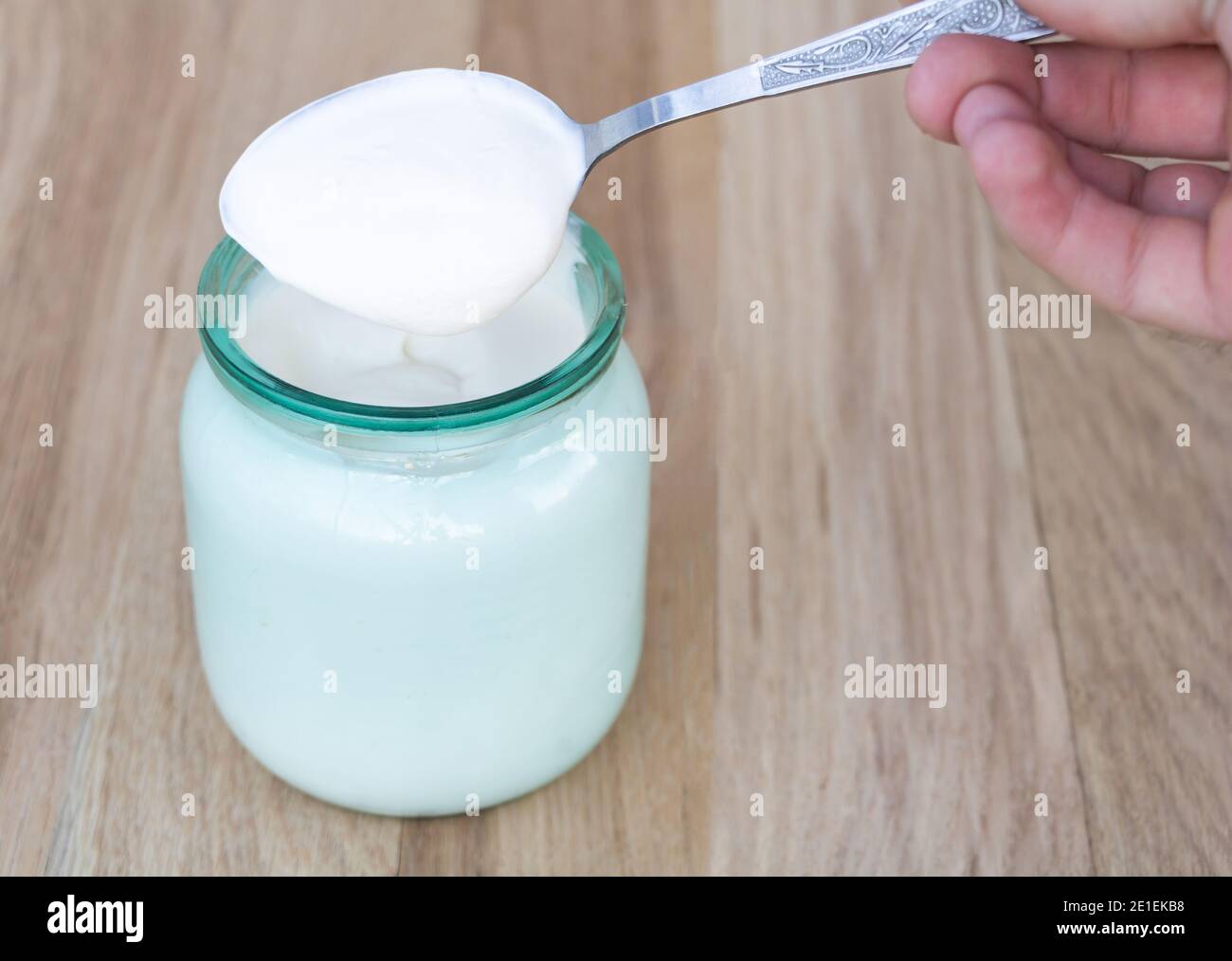 A full spoon with natural sour cream, with many health benefits Stock