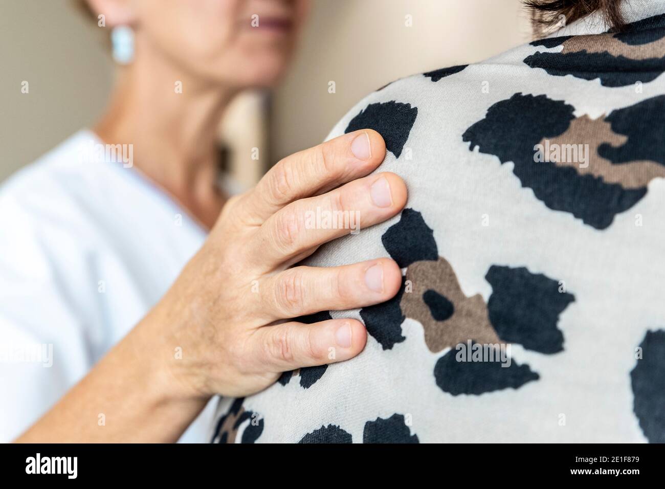 a caregiver comforts a patient Stock Photo