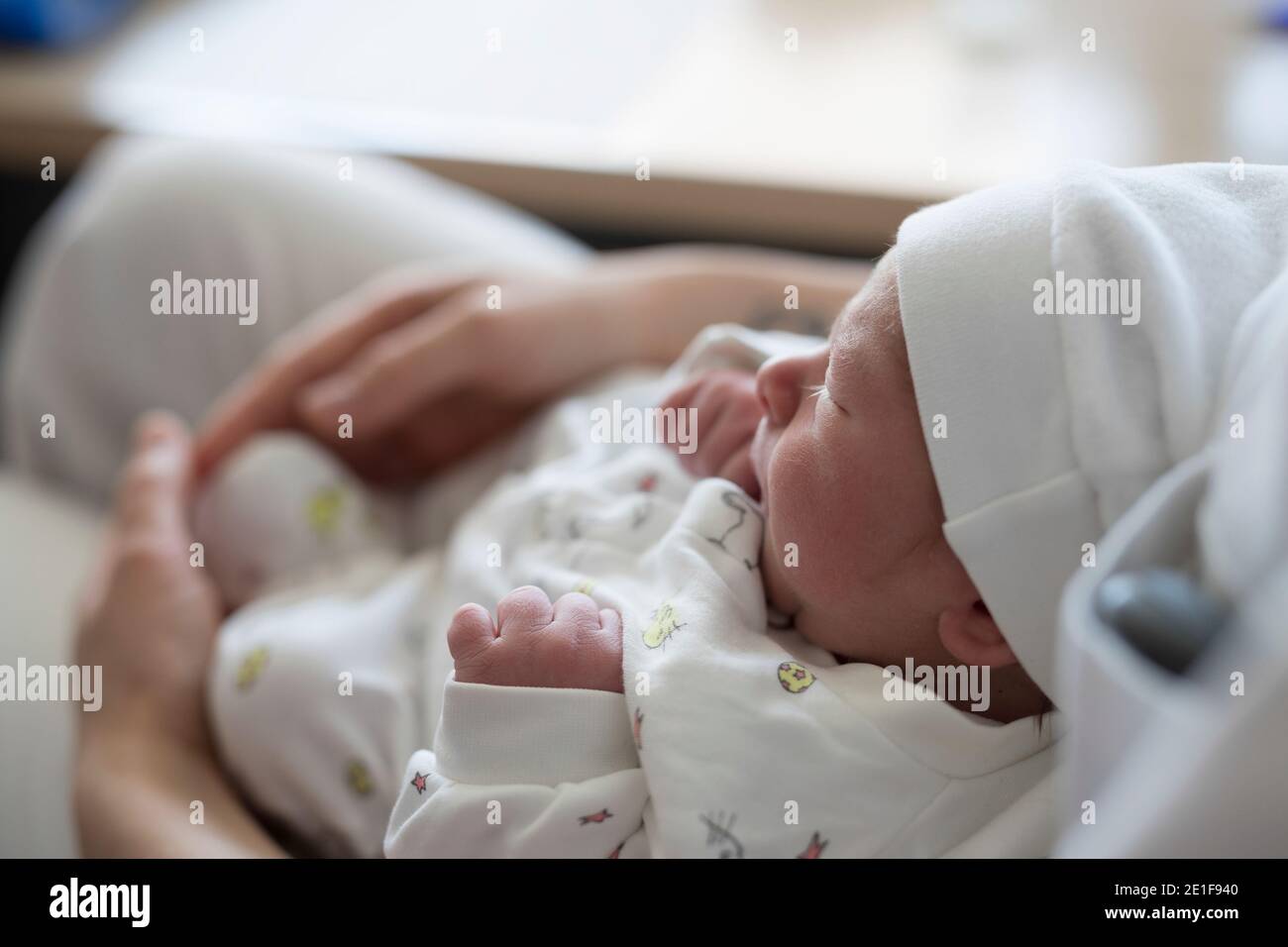 newborn baby sleeping in the arms of a nurse Stock Photo Alamy