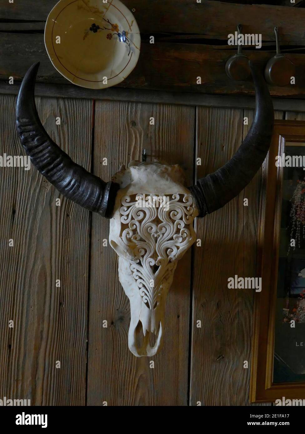 CHATEL, FRANCE - FEB 20, 2018 - Carved skull and horns decorate a rerstaurant in small alpine village of Chatel, France Stock Photo