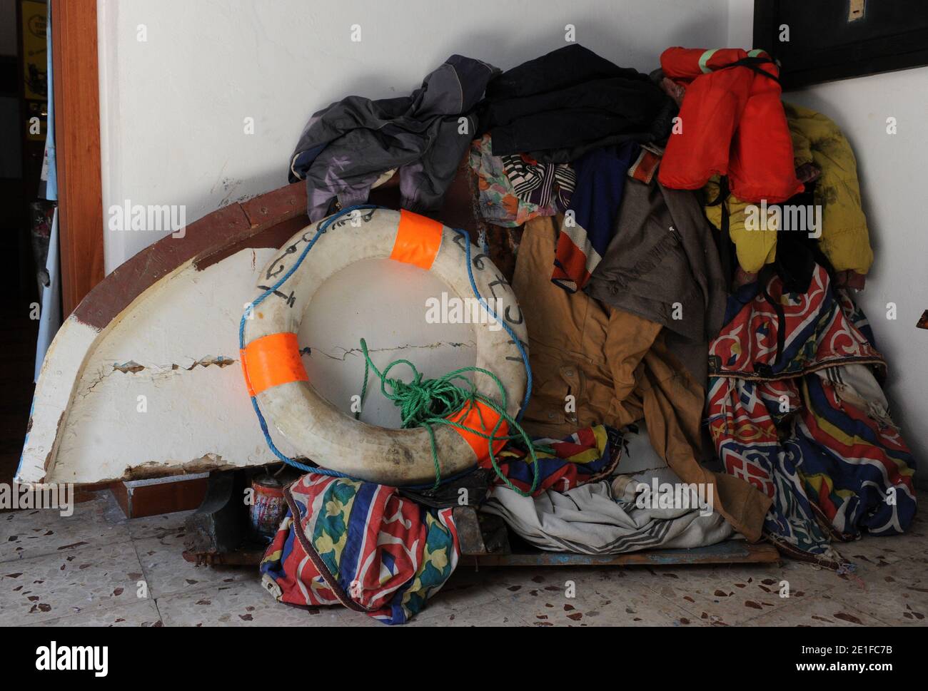 Giacomo Sferlazzo curates the Museum of the Immigrants, located in a two-room apartment in Lampedusa, Italy on march 12,2011, the italian island overwhelmed by thousands of illegal immigrants from Africa. Inside the museum, mismatched shoes hang from the ceiling: a striped flip-flop and a sneaker without its match. Since 2005 Giacomo Sferlazzo and some friends have been collecting such items from inside discarded boats or after they wash up on Lampedusa?s beaches. They?ve found letters sewn into small packages or inside a pair of pants, documents, phone books, email addresses , cooking utensil Stock Photo