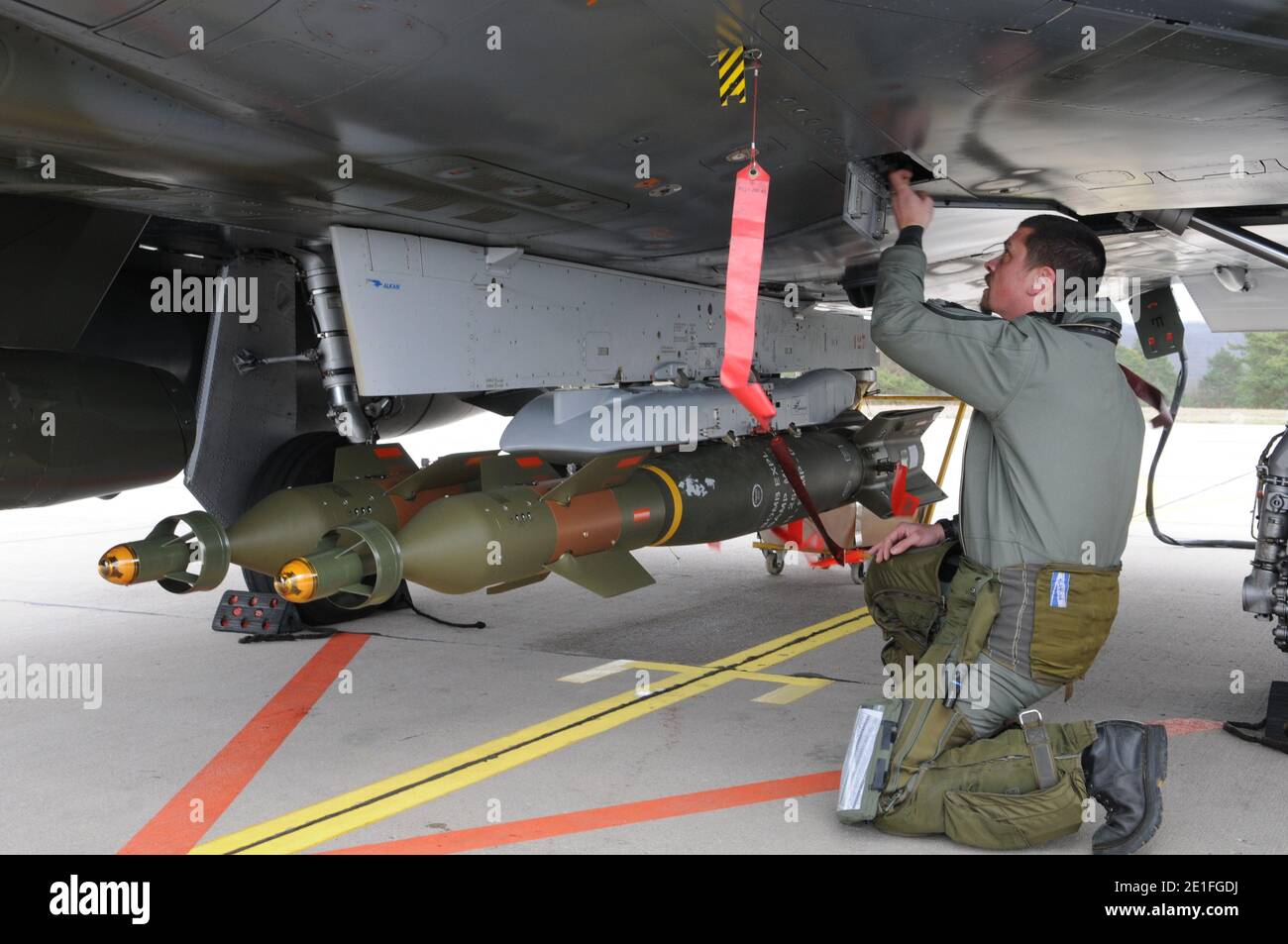 French air force personnel mounted a GBU12 bomb on a Mirage 2000D plane prior to take off from Nancy military base, France, on March 19, 2011, on a mission to overfly Libya following UN Security Council resolution. Photo by ECPAD/ABACAPRESS.COM Stock Photo