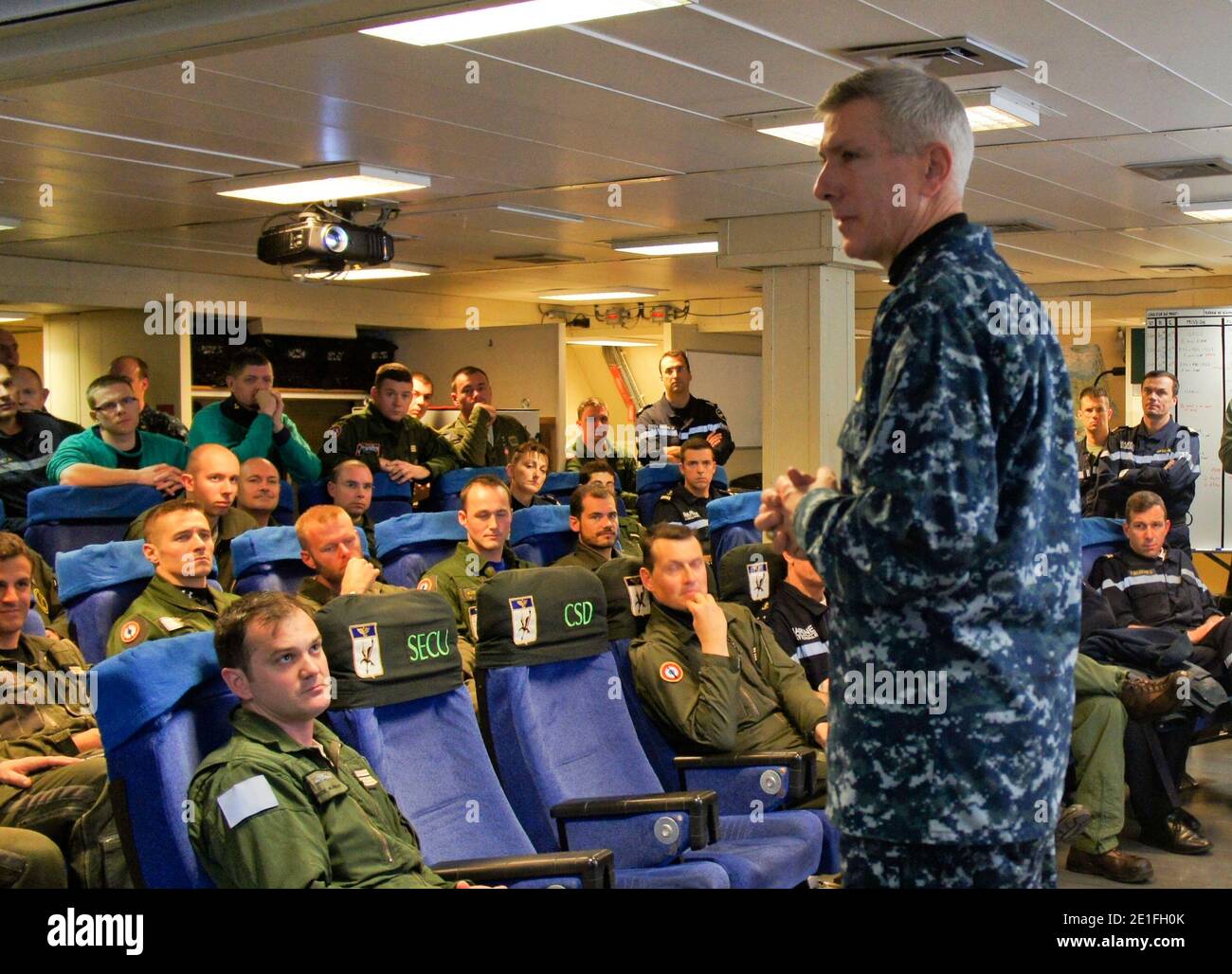 Adm. Samuel J. Locklear, III, commander, Joint Task Force Odyssey Dawn, speaks with an aircrew team from the French Navy aircraft carrier Charles de Gaulle (R91). Charles de Gaulle is operating in the Mediterranean Sea supporting the coalition led operations in response to the crisis in Libya. Joint Task Force Odyssey Dawn is the U.S. Africa Command task force established to provide operational and tactical command and control of U.S. military forces supporting the international response to the unrest in Libya and enforcement of United Nations Security Council Resolution (UNSCR) 1973. UNSCR 19 Stock Photo