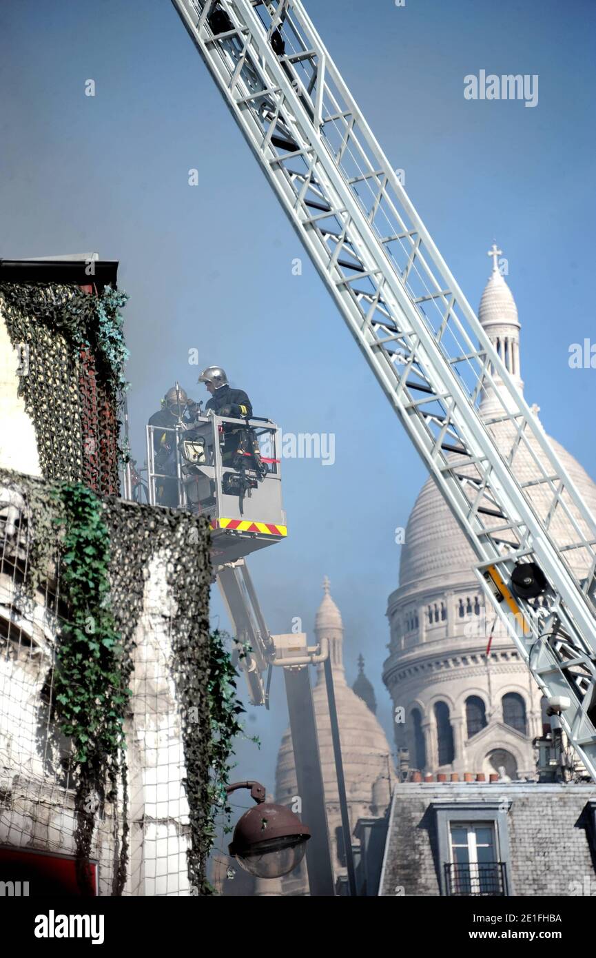 Smoke rises near the Sacre-Coeur de Montmartre basilica, in Paris, France on March 22, 2011, from the Elysee Montmartre music hall where a fire broke out this morning. The cabaret, created in the XVIIIth century, is one of the birth places of famous French Cancan. Photo by ABACAPRESS.COM Stock Photo