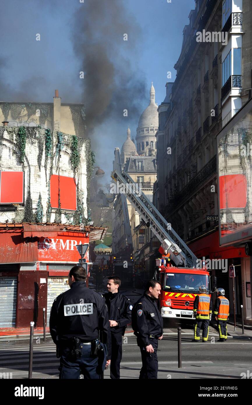 Smoke rises near the Sacre-Coeur de Montmartre basilica, in Paris, France on March 22, 2011, from the Elysee Montmartre music hall where a fire broke out this morning. The cabaret, created in the XVIIIth century, is one of the birth places of famous French Cancan. Photo by ABACAPRESS.COM Stock Photo