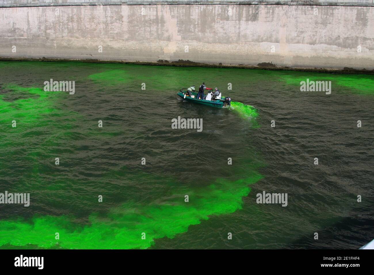 Environment emplyees tip a fluorescent product into the river Seine, Paris, France on March 22, 2011, as part of the World Water Day celebrations. The UN's food agency marked World Water Day, today by calling for new and innovative approaches to ensuring city dwellers in developing countries have access to safe and adequate water supplies. Photo by David Fritz/ABACAPRESS.COM Stock Photo