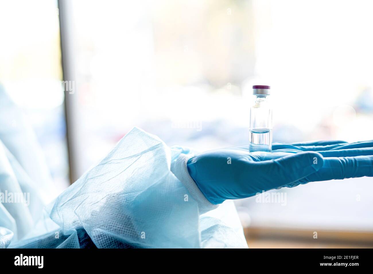 Medical doctor or laborant holding tube with nCoV Coronavirus vaccine for 2019-nCoV virus. Stock Photo
