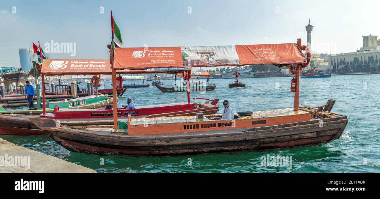 Dubai, UAE - JAN 23, 2016: Dubai Water Canal on an traditional wooden abra. water taxi traditional Arabic boats, RTA Abra water taxi station in Deira, Stock Photo