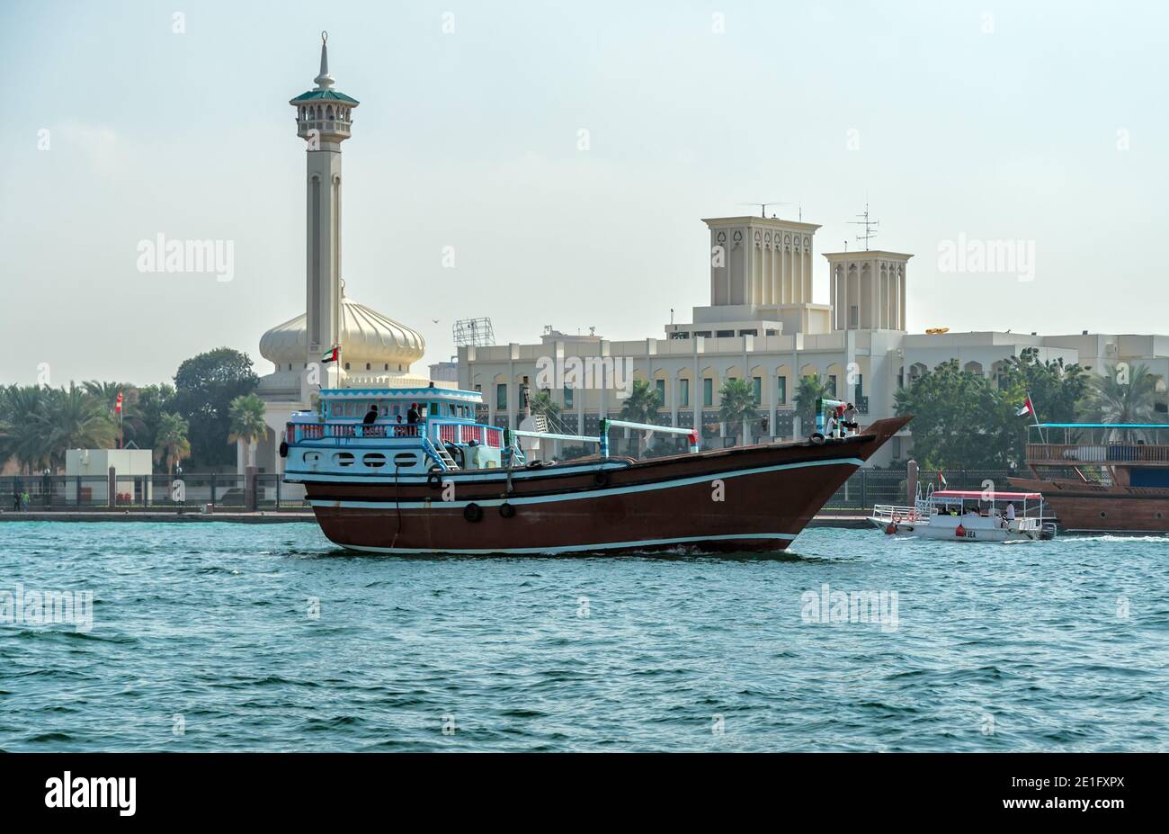 Dubai, UAE - JAN 23, 2016: Traditional wooden small cargo ships Dhows in Dubai, Deira creek, United Arab Emirates Stock Photo