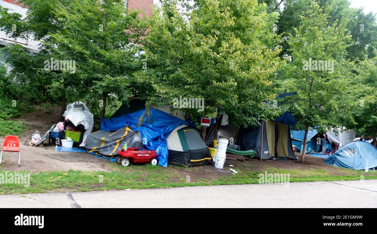 Several tents for the homeless camping next to the Midtown Greenway Trail used by bicycles and walkers. Minneapolis Minnesota MN USA Stock Photo