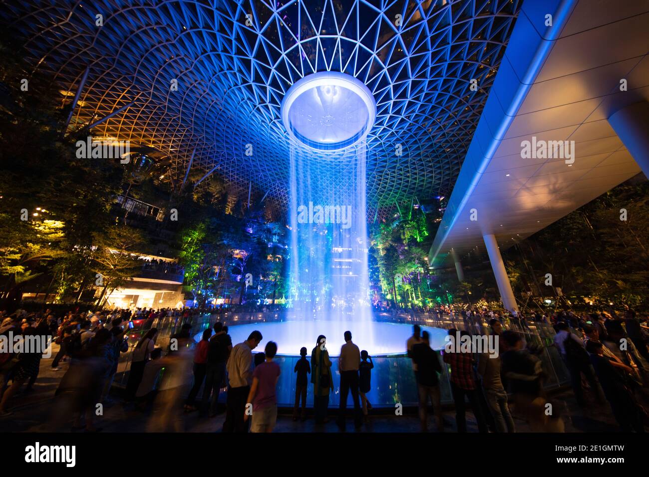 The Jewel Changi Airport in Singapore at night. A mixed use development complex featuring a rain vortex, the largest indoor waterfall in the world. Stock Photo