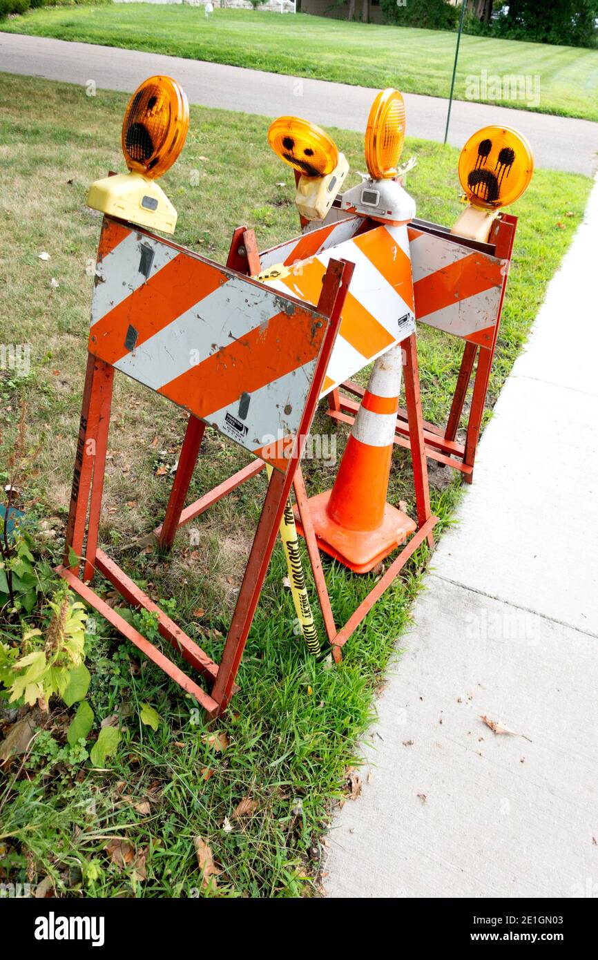 Stripped street warning flashing signs with faces drawn on the flashers. St Paul Minnesota MN USA Stock Photo