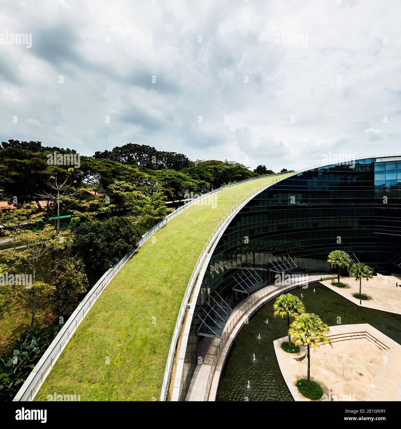 Exterior view of the School of Art, Design & Media at NTU, a glass building with green roof, Singapore. Stock Photo