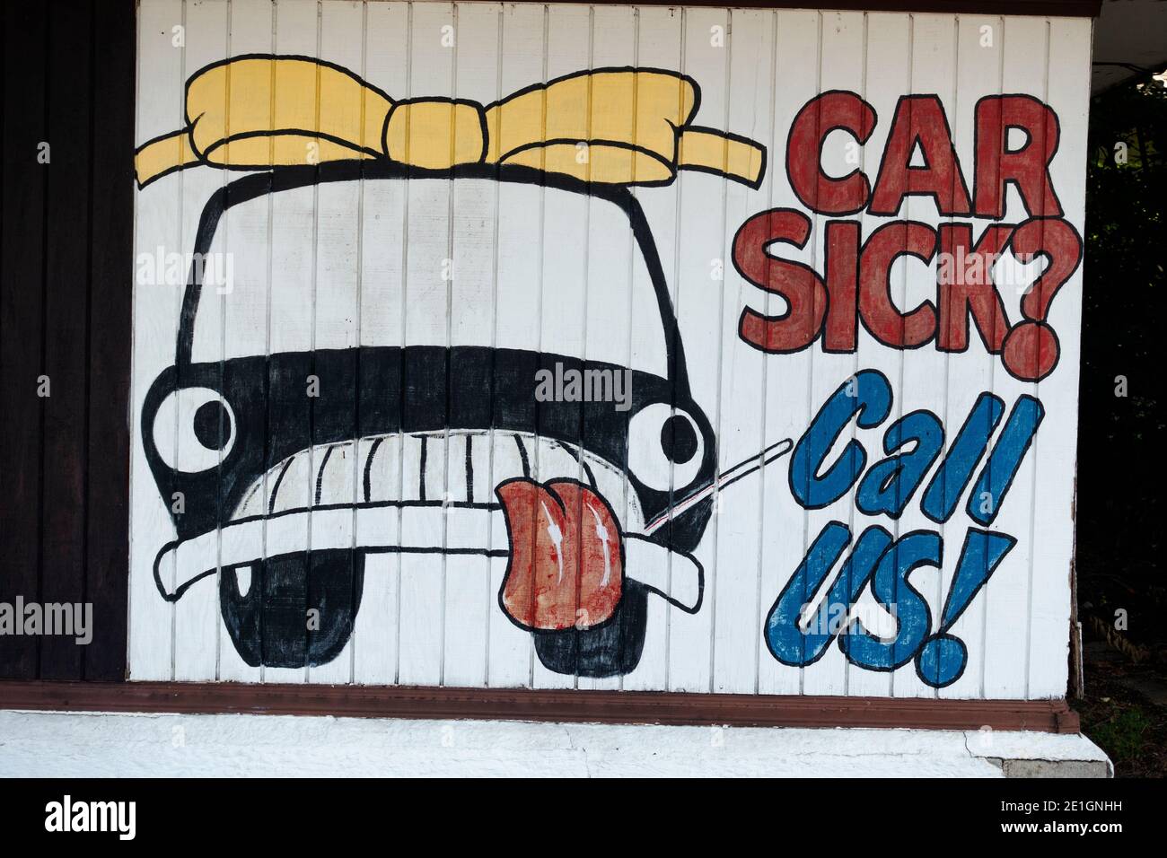 Fun painted sign 'Car Sick? Call Us!' advertising a garage for car repair. Minneapolis Minnesota MN USA Stock Photo