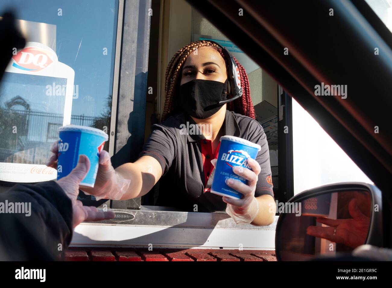 Picking up Dairy Queen drive through blizzards with clerk wearing mask and gloves due to Covid Pandemic. St Paul Minnesota MN USA Stock Photo
