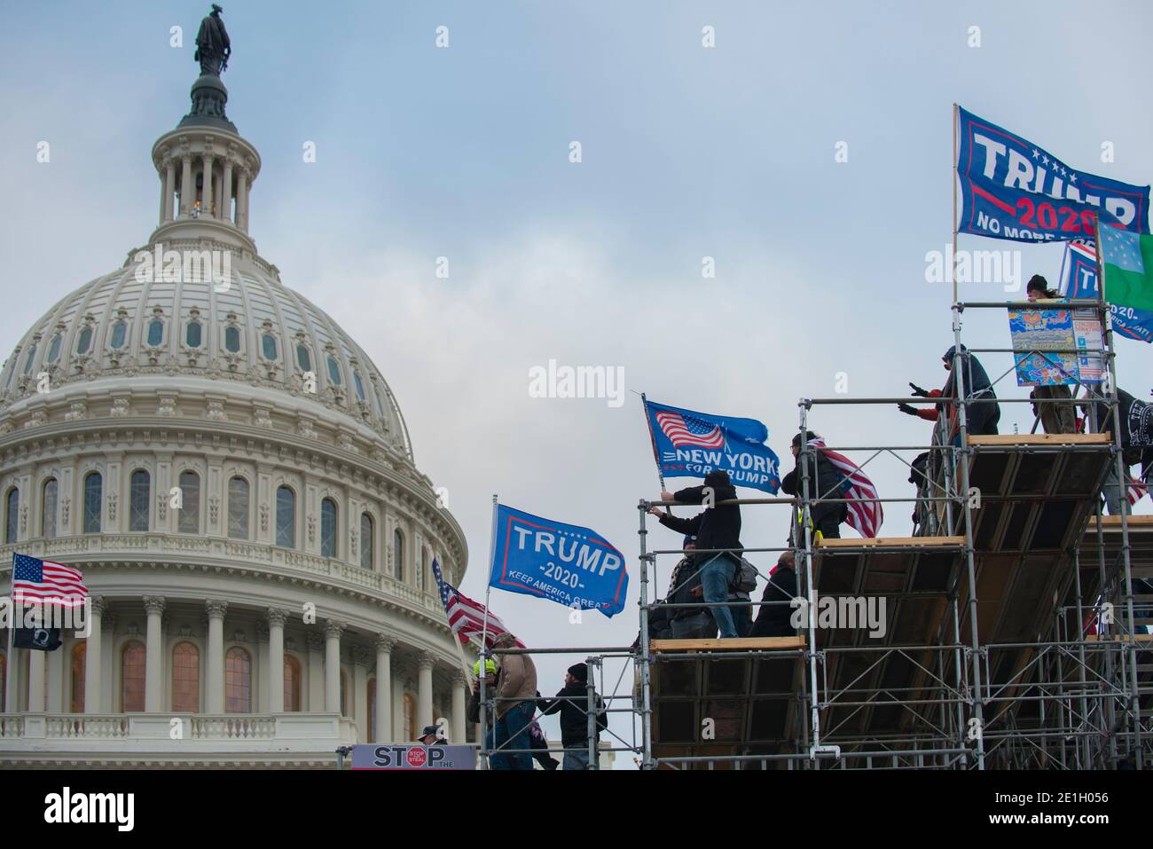 January 6th 2021.Capitol Hill Rioters with Trump flags standing on media scaffolding built for Biden Inaugural. US Capitol Building  Washington DC.USA Stock Photo