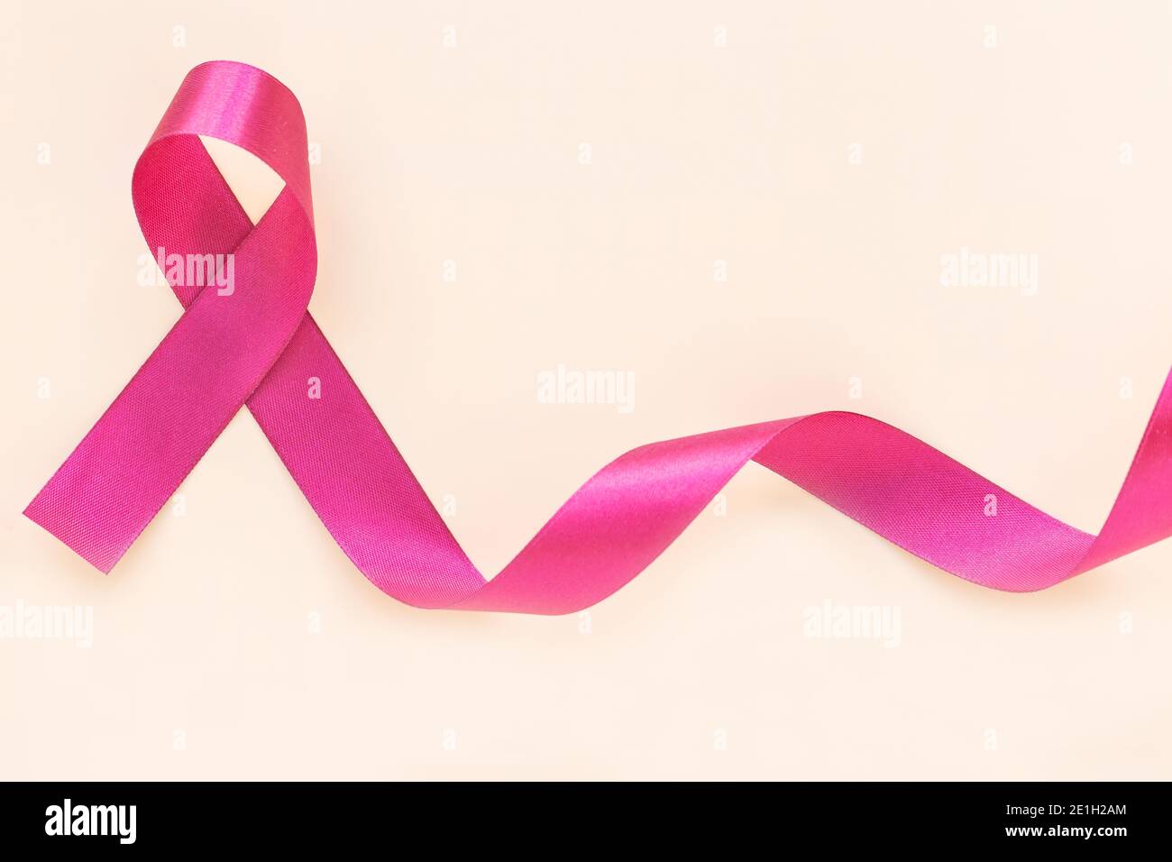 Red burgundy ribbon bow curl on isolated pastel beige background with ...