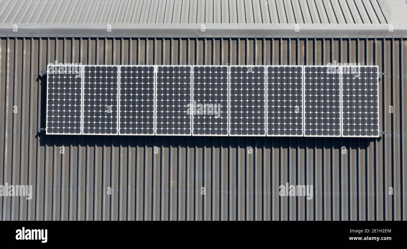 Top down view of domestic solar panel installation on grey metal residential roof Stock Photo