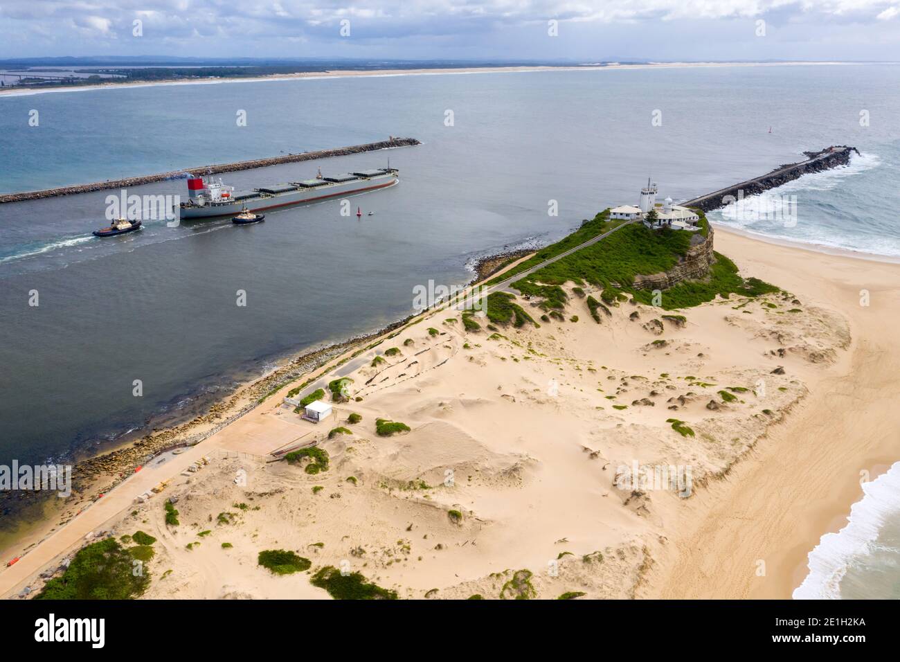 Large ocean coal ship leaving Newcastle Harbour - NSW Australia. Newcastle is one of the largest coal export ports in the world. Stock Photo