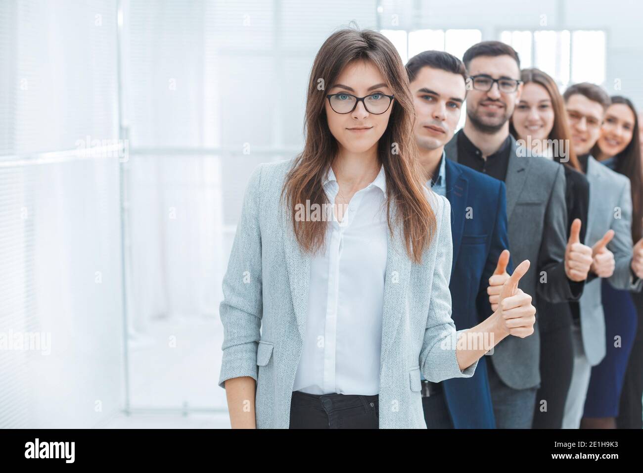 group of young business people showing thumbs up Stock Photo - Alamy