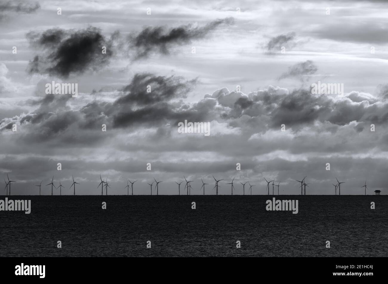 rampion wind farm on horizon in black and white Stock Photo
