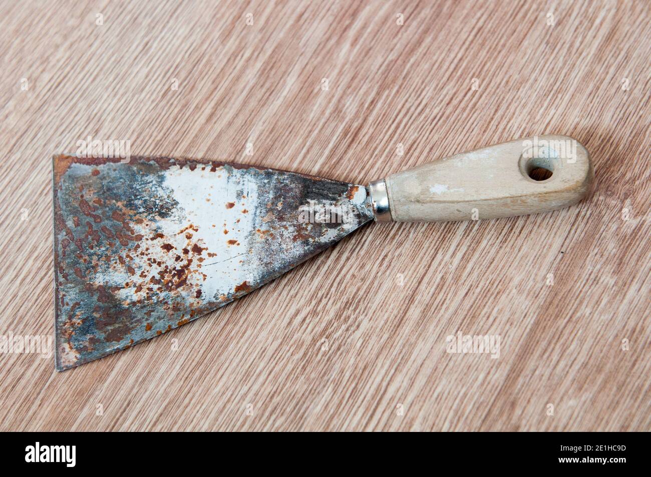 Putty kniFe with wooden handle over isolated white background Stock