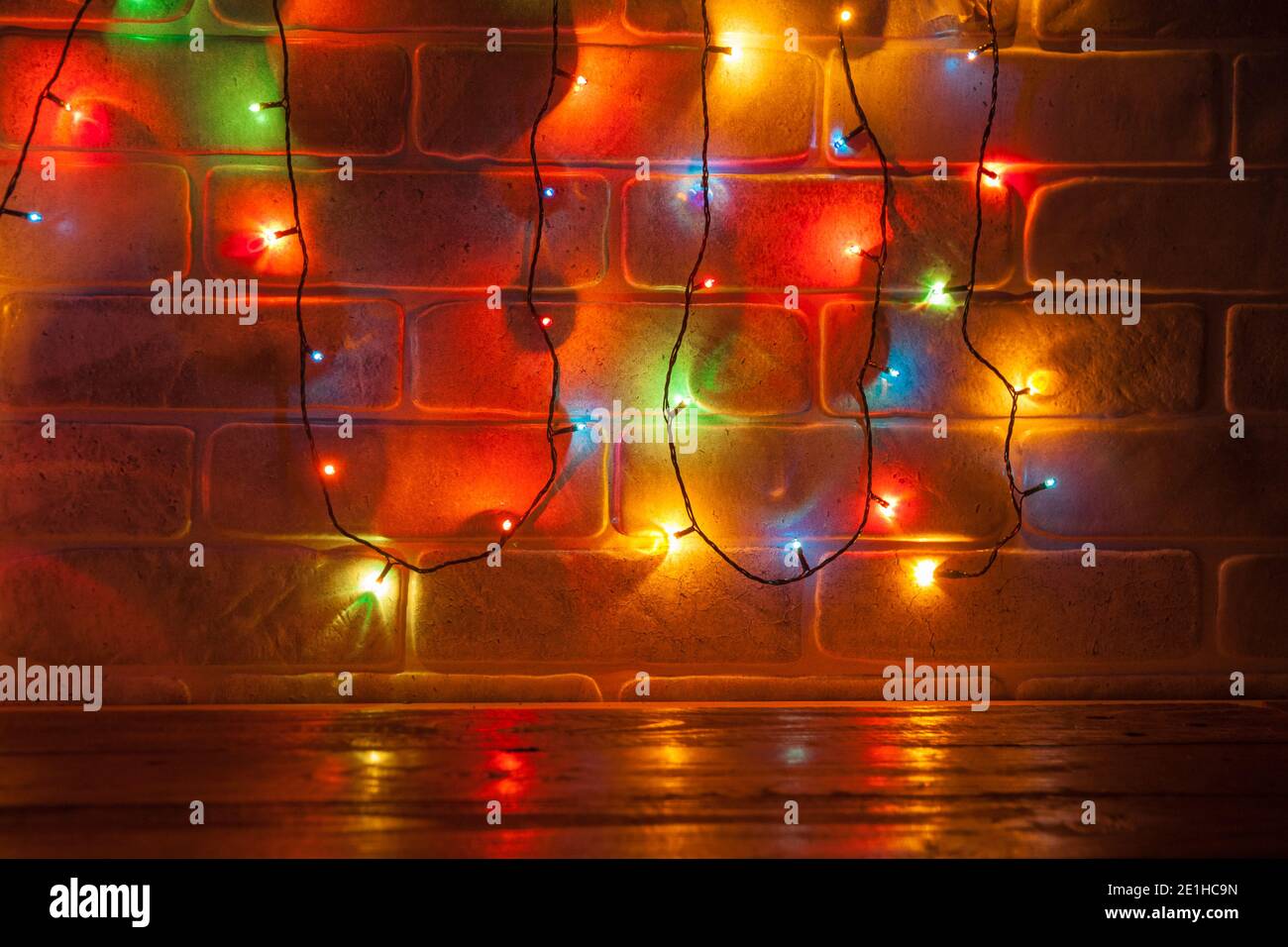 Christmas colorful lights on stone wall background. The concept of a