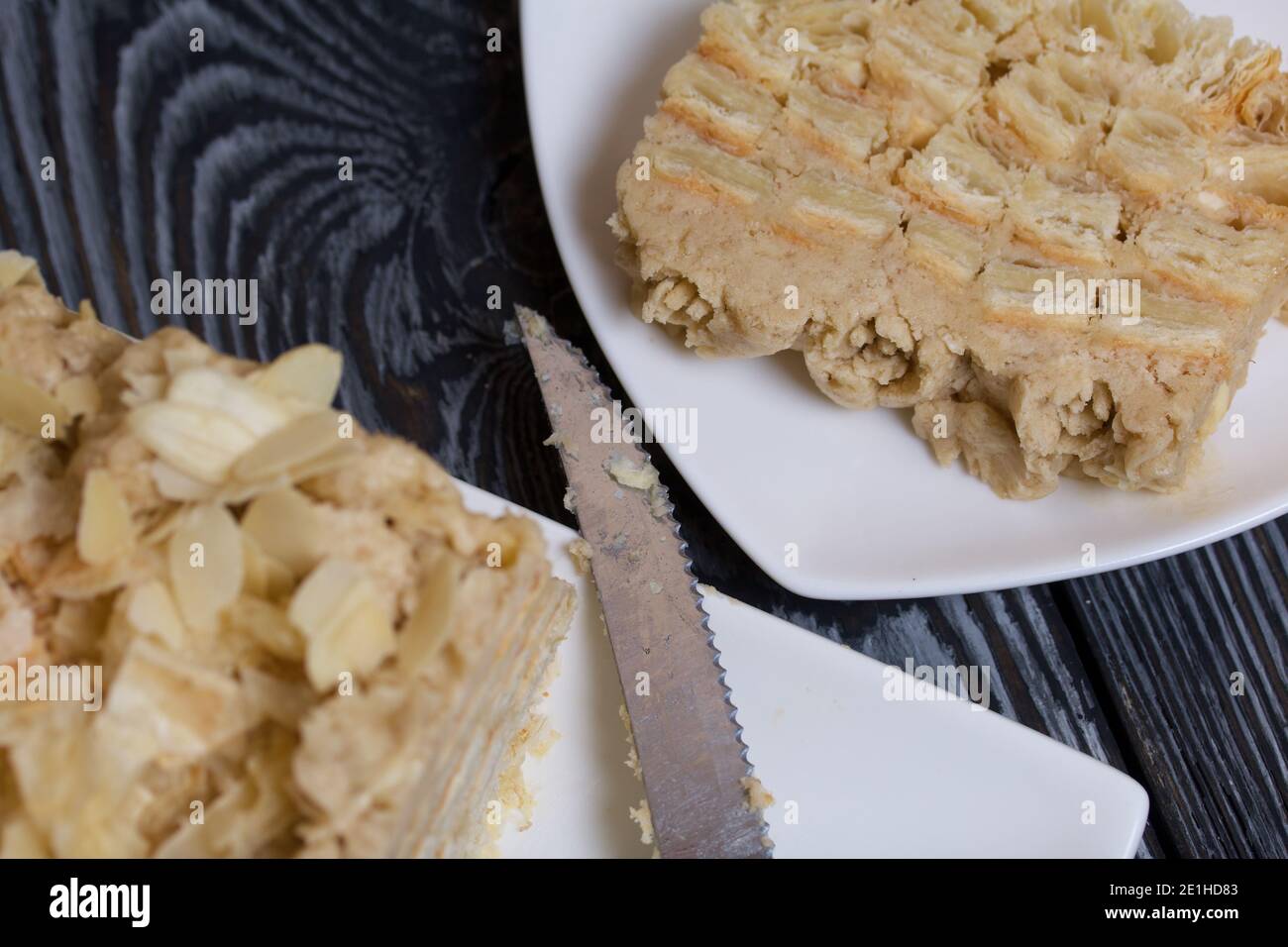 Puff pastry cake. With banana cream and almond petals Stock Photo Alamy