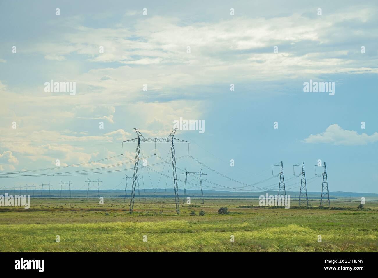 Many power lines in field. Power lines on background of blue sky with ...