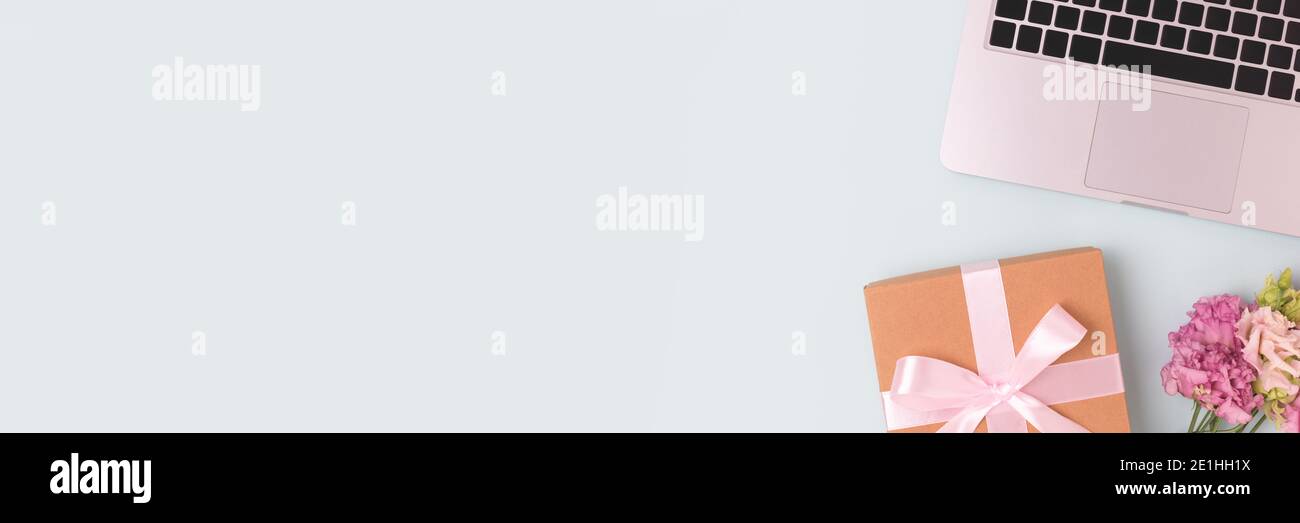 Banner with laptop, bouquet of flowers and gift box with tied bow