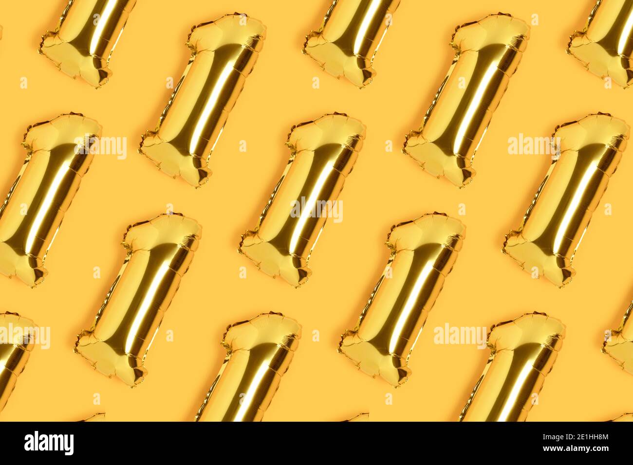 Number 1 golden balloons pattern. One year anniversary celebration concept on a yellow background. Stock Photo