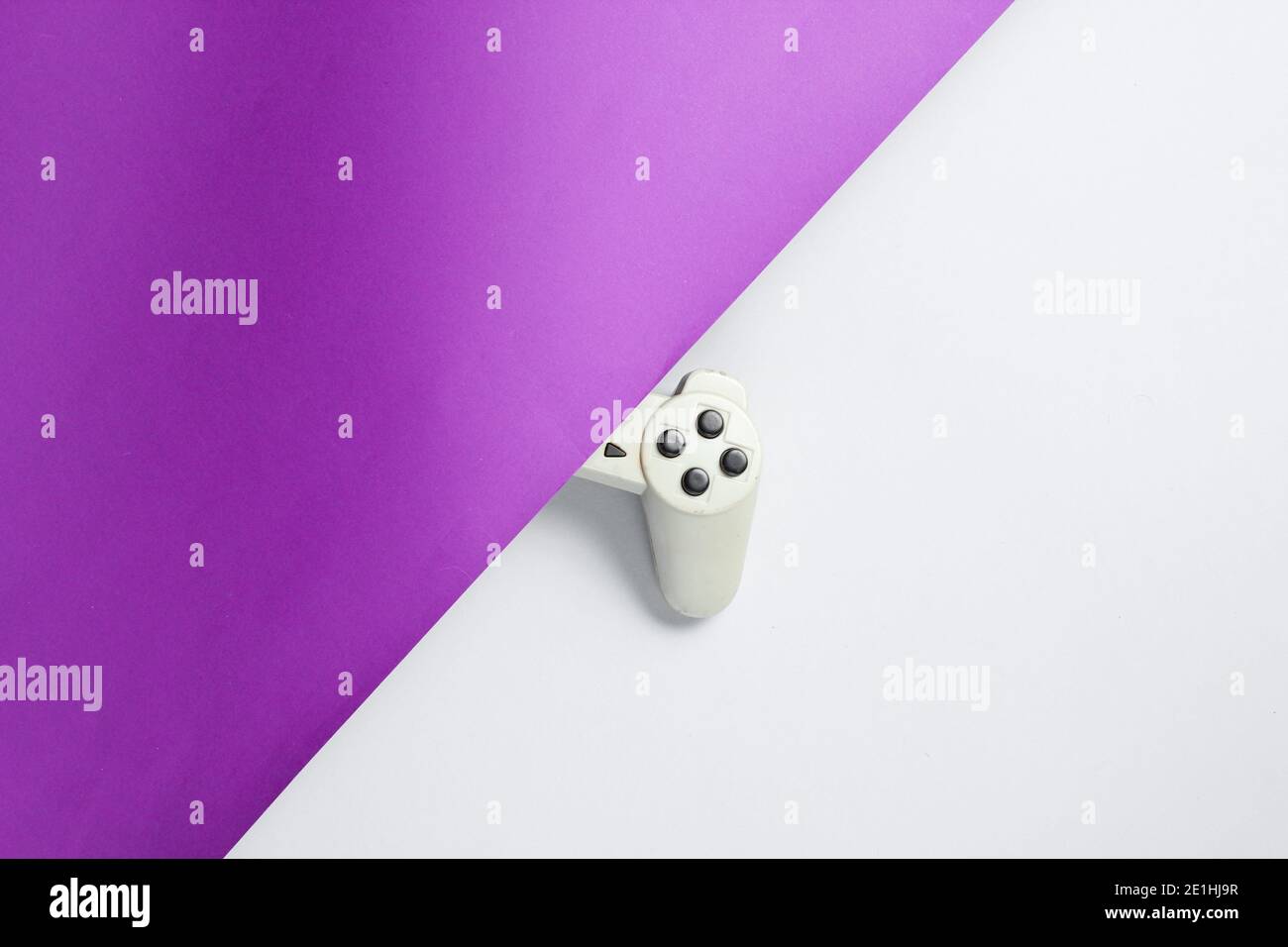Half gamepad  on purple-gray background. Retro style 80s. Top view Stock Photo