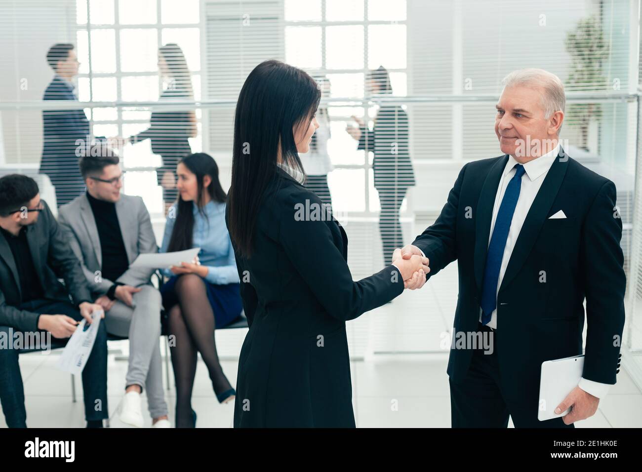 boss and the assistant discuss a business document. Stock Photo