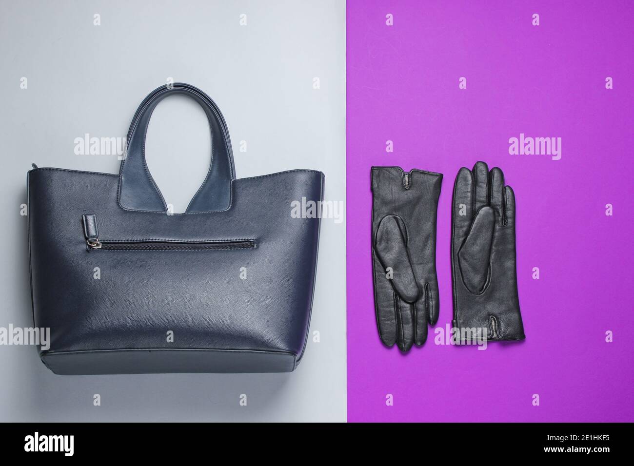 Women's fashion accessories on a graypurple background. Leather bag