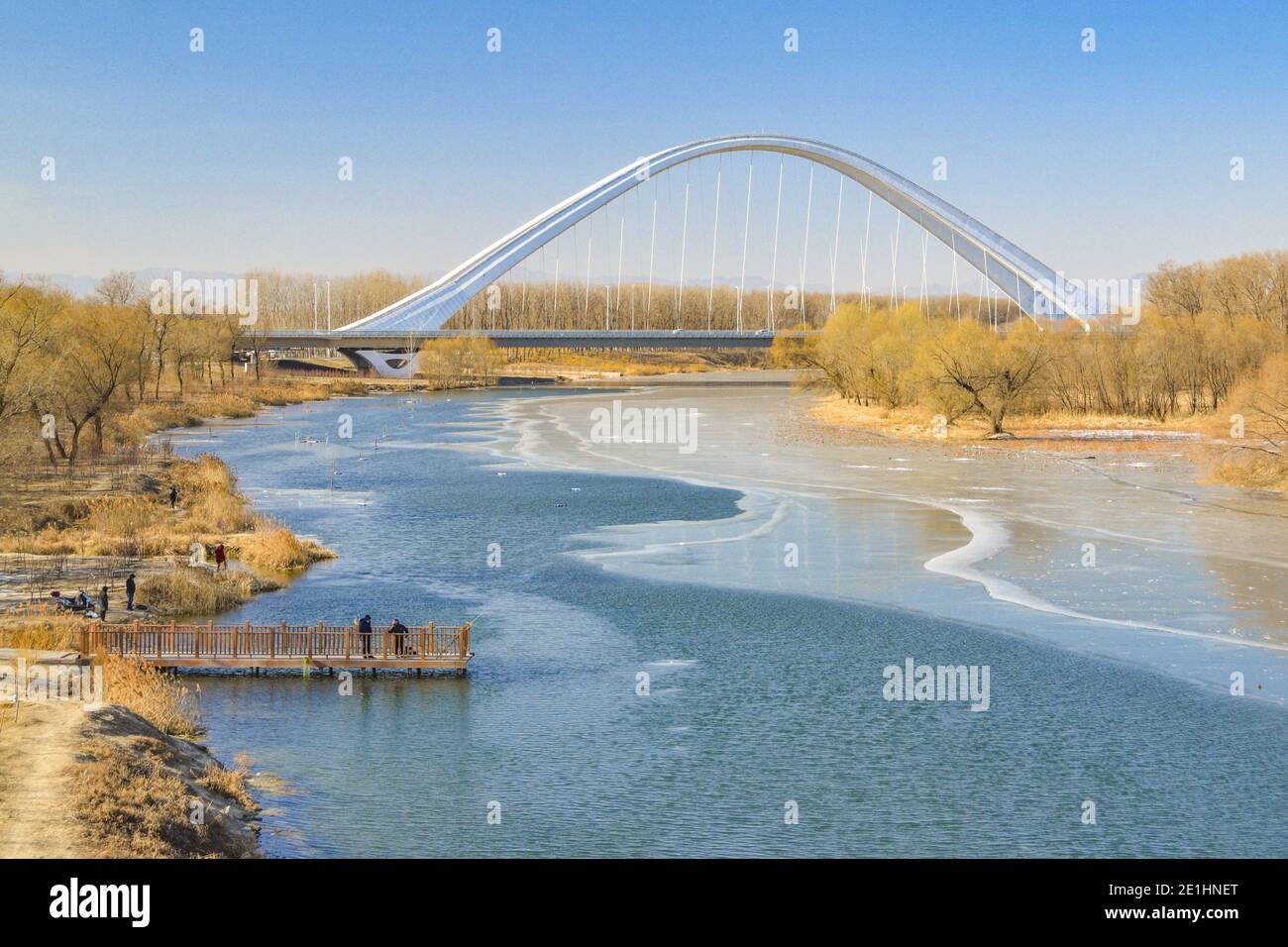 Changping, Changping, China. 7th Jan, 2021. Beijing, CHINA-On January 4,  2021, a group of ice fishing enthusiasts gathered on the ice surface of  Wenyu River at the East Road Bridge of Future