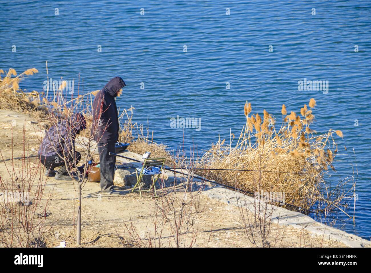 Changping, Changping, China. 7th Jan, 2021. Beijing, CHINA-On January 4,  2021, a group of ice fishing enthusiasts gathered on the ice surface of  Wenyu River at the East Road Bridge of Future
