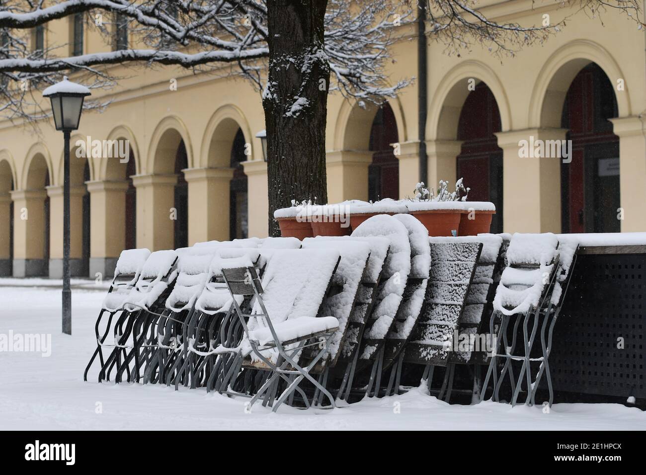 Topic picture: Winter in times of the coronavirus pandemic/extension of lockdown until January 31, 2021. Consequences for gastronomy Snow-covered, stacked and folded chairs and tables in a beer garden in the Hofgarten in Munich on January 6, 2021. | usage worldwide Stock Photo